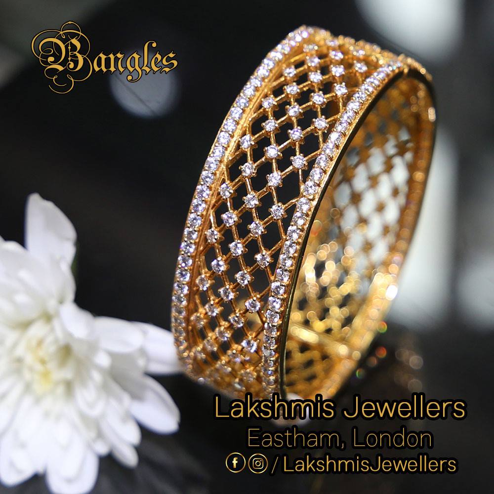 A gold bangle set with a lattice of small diamonds, at Lakshmis Jewellers, East Ham