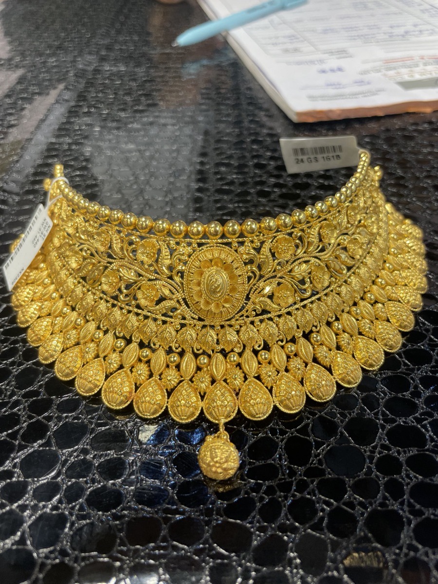 An intricate 22-carat style gold bridal choker necklace with floral filigree, on display at Lakshmis Jewellers, East Ham
