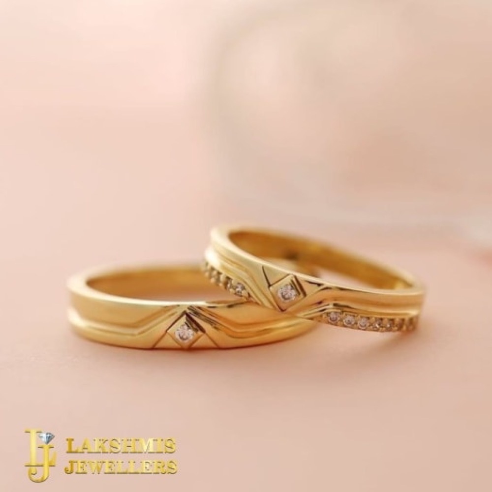 A pair of gold wedding bands with diamond accents at Lakshmis Jewellers, East Ham
